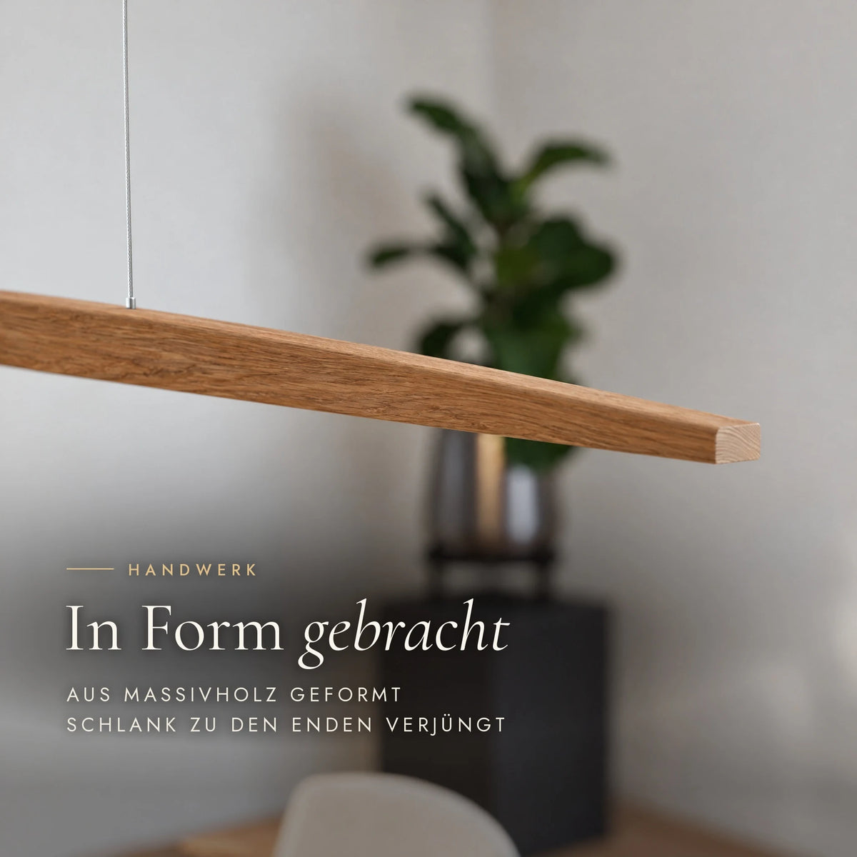 Close-up of the Elia pendant light: shaped from solid wood and tapering slimly towards the ends, with visible end grain