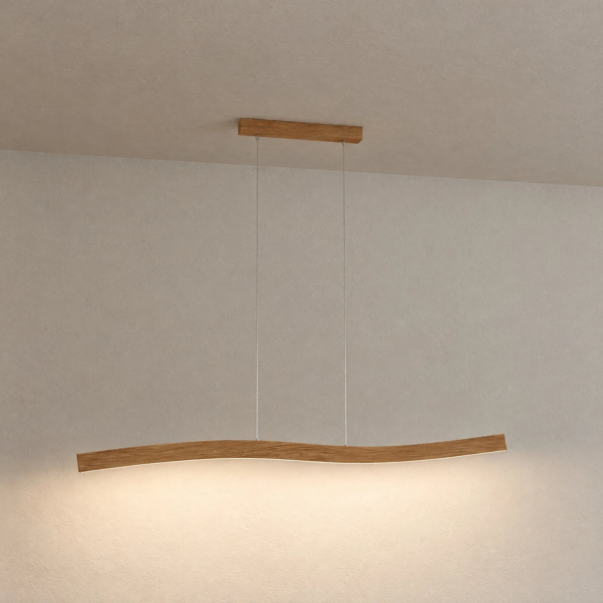 Lyra oak pendant light hanging freely against a light plaster wall, gently curved form