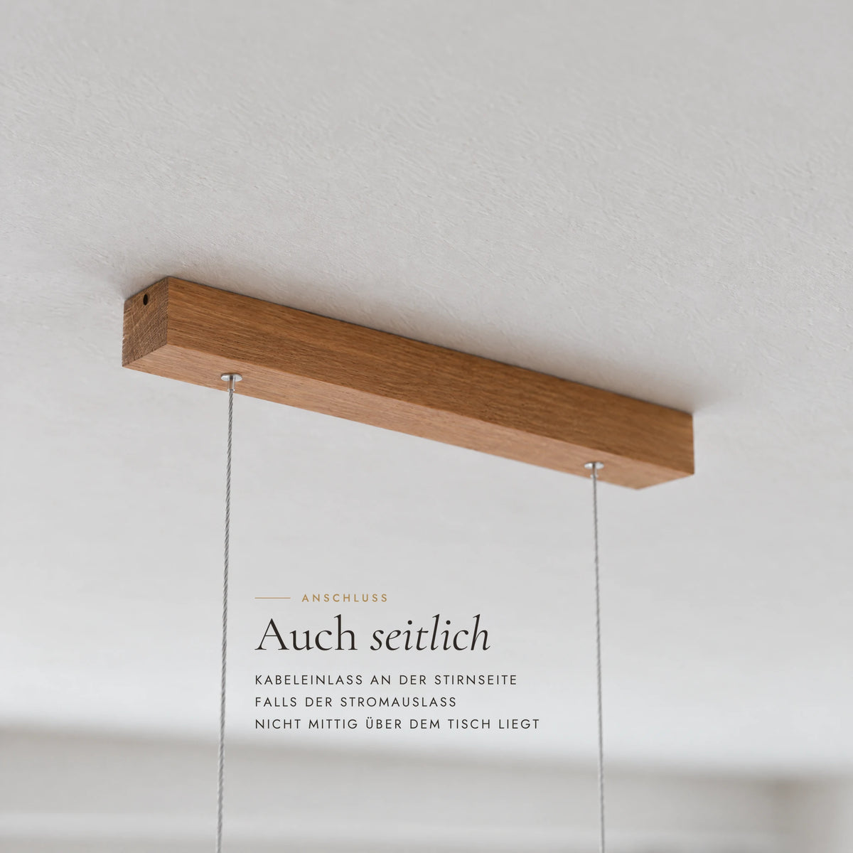 Solid wood ceiling canopy of the Mila pendant light with a side cable entry at the end, for when the power outlet is not centred above the table