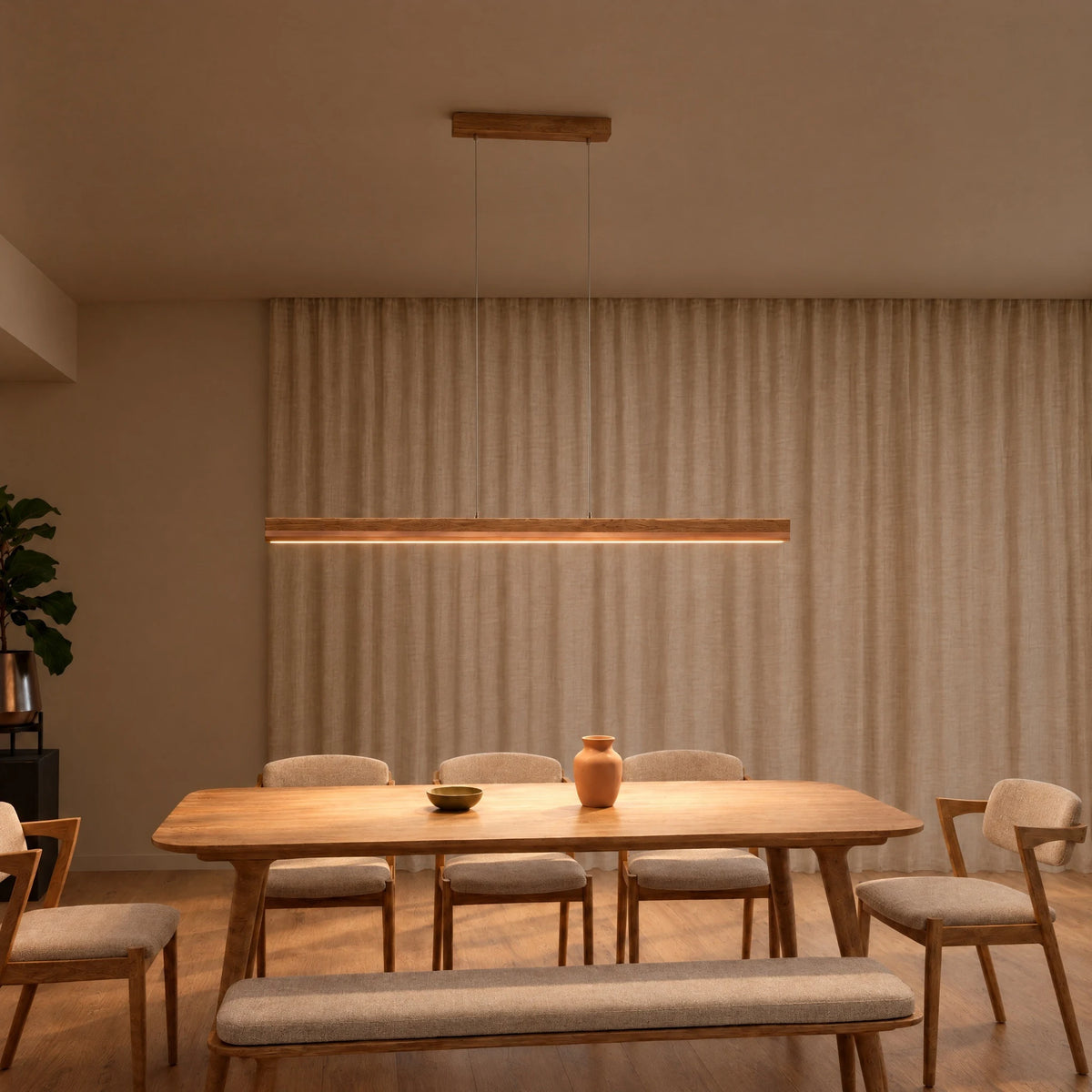 SpeicherArt Veta pendant light: straight solid oak light with copper inlay, switched on above a wooden dining table in front of a light linen curtain